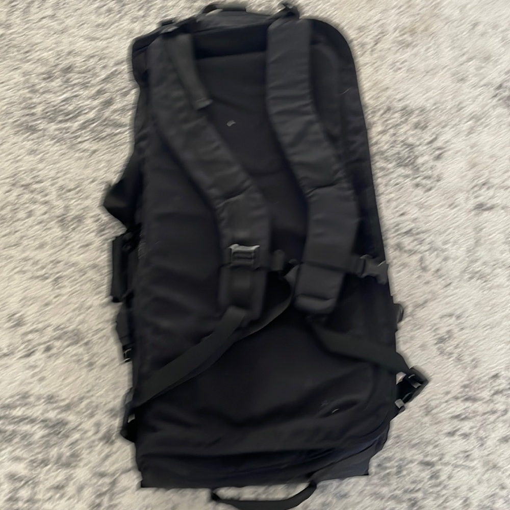 Force Protector Gear Large Black Suitcase with wheels and backpack straps.